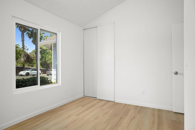4888 Northerly St, Oceanside, CA 92056 - unfurnished bedroom featuring light wood finished floors, vaulted ceiling, baseboards, and a closet