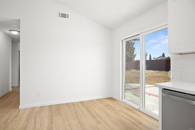 4888 Northerly St, Oceanside, CA 92056 - unfurnished room with light wood-style flooring, lofted ceiling, baseboards, and a textured ceiling