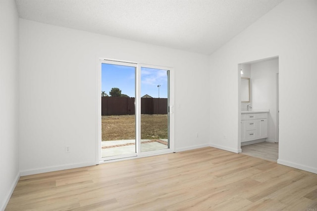 4888 Northerly St, Oceanside, CA 92056 - unfurnished room featuring light wood-type flooring, vaulted ceiling, and baseboards