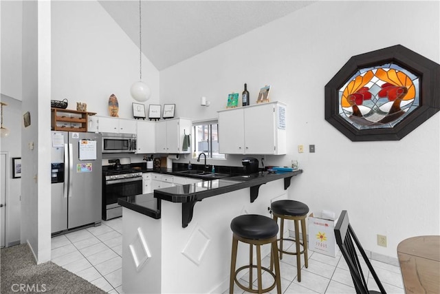 1983 Cirlce Dr, Cayucos, CA 93430 - kitchen with stainless steel appliances, high vaulted ceiling, a sink, a peninsula, and light tile patterned floors