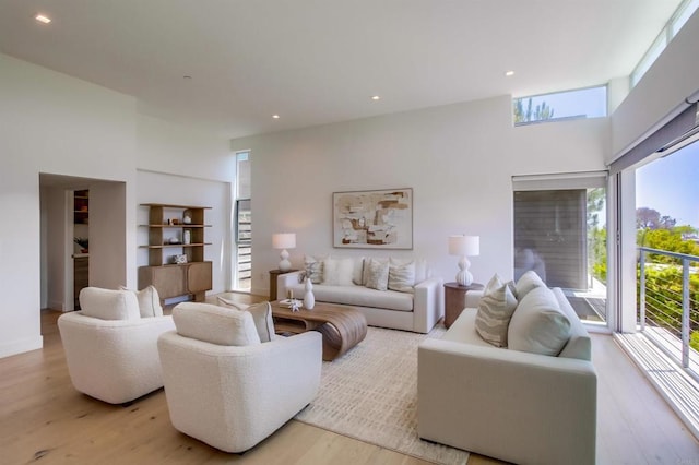 747 S Cedros Ave, Solana Beach, CA 92075 - living area with a high ceiling, light wood-style floors, built in features, and recessed lighting
