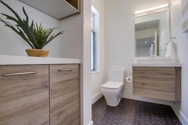 747 S Cedros Ave, Solana Beach, CA 92075 - bathroom featuring toilet, brick patterned flooring, vanity, and baseboards