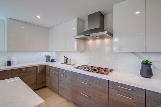 747 S Cedros Ave, Solana Beach, CA 92075 - kitchen with wall chimney exhaust hood, modern cabinets, stainless steel gas cooktop, and light stone countertops
