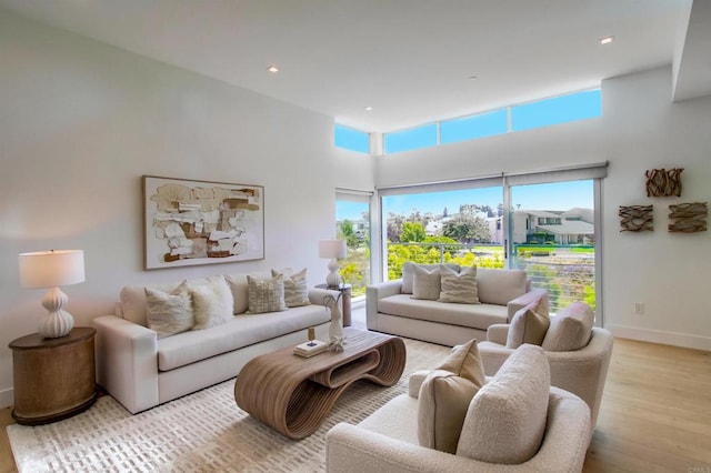 747 S Cedros Ave, Solana Beach, CA 92075 - living room with wood finished floors, healthy amount of natural light, baseboards, a towering ceiling, and recessed lighting