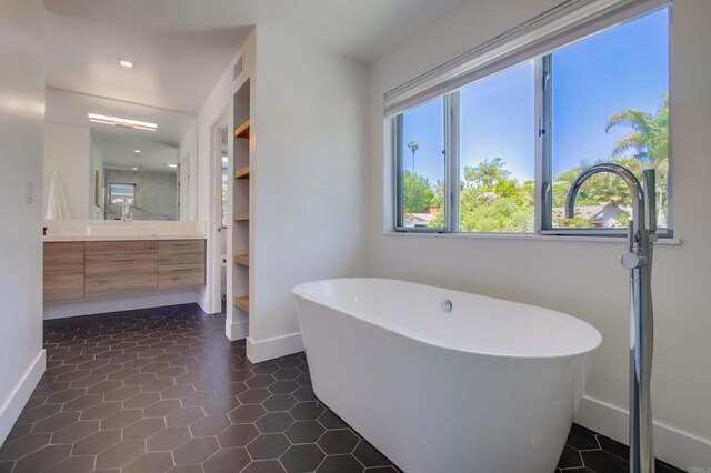747 S Cedros Ave, Solana Beach, CA 92075 - bathroom featuring baseboards, vanity, a freestanding tub, and tile patterned flooring