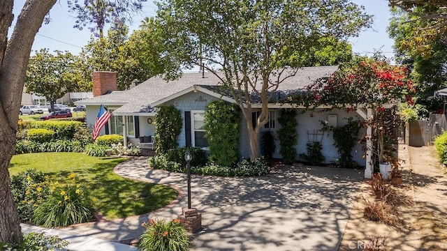 577 S Albertson Ave, Covina, CA 91723 - view of front of house with a chimney, a front yard, roof with shingles, and stucco siding
