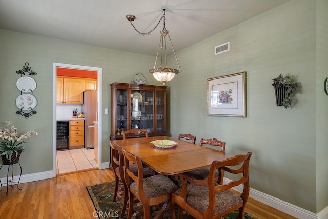 577 S Albertson Ave, Covina, CA 91723 - dining space with light wood-type flooring, baseboards, and beverage cooler