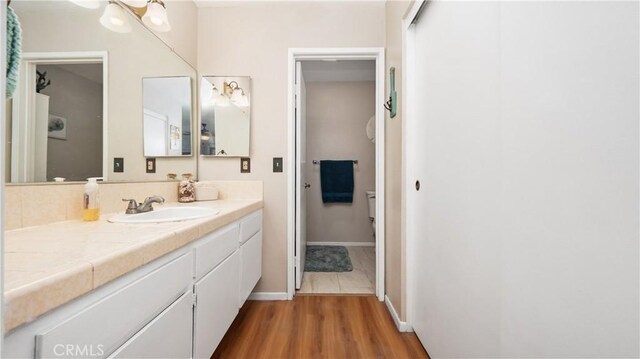 3458 Santa Barbara Ct, Palmdale, CA 93550 - bathroom featuring vanity, wood finished floors, baseboards, and toilet