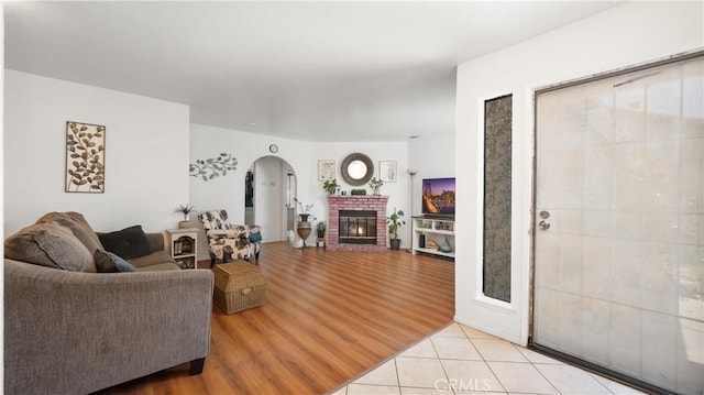 3458 Santa Barbara Ct, Palmdale, CA 93550 - living room featuring arched walkways, light tile patterned flooring, and a fireplace