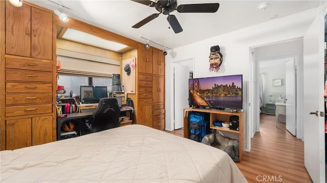 3458 Santa Barbara Ct, Palmdale, CA 93550 - bedroom featuring wood finished floors, rail lighting, an office area, and a ceiling fan