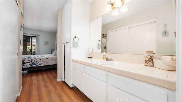 3458 Santa Barbara Ct, Palmdale, CA 93550 - bathroom with vanity, connected bathroom, and wood finished floors