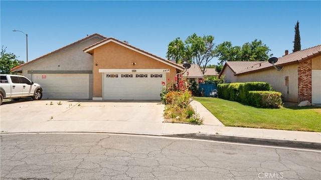 3458 Santa Barbara Ct, Palmdale, CA 93550 - view of front of property featuring a garage, a front yard, driveway, and stucco siding
