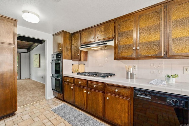 1466 Pacific Ave, Norco, CA 92860 - kitchen with black appliances, under cabinet range hood, tasteful backsplash, light carpet, and baseboards