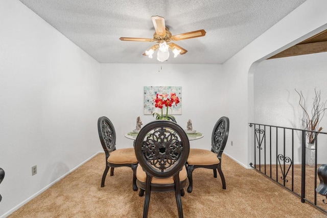 1466 Pacific Ave, Norco, CA 92860 - carpeted dining area with ceiling fan, a textured ceiling, arched walkways, and baseboards