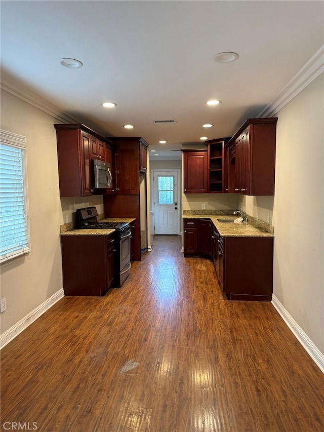 1030 E M St, Wilmington, CA 90744 - kitchen featuring stainless steel appliances, crown molding, dark wood-type flooring, baseboards, and light stone counters