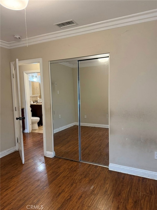 1030 E M St, Wilmington, CA 90744 - unfurnished bedroom featuring ornamental molding, a closet, wood finished floors, and baseboards