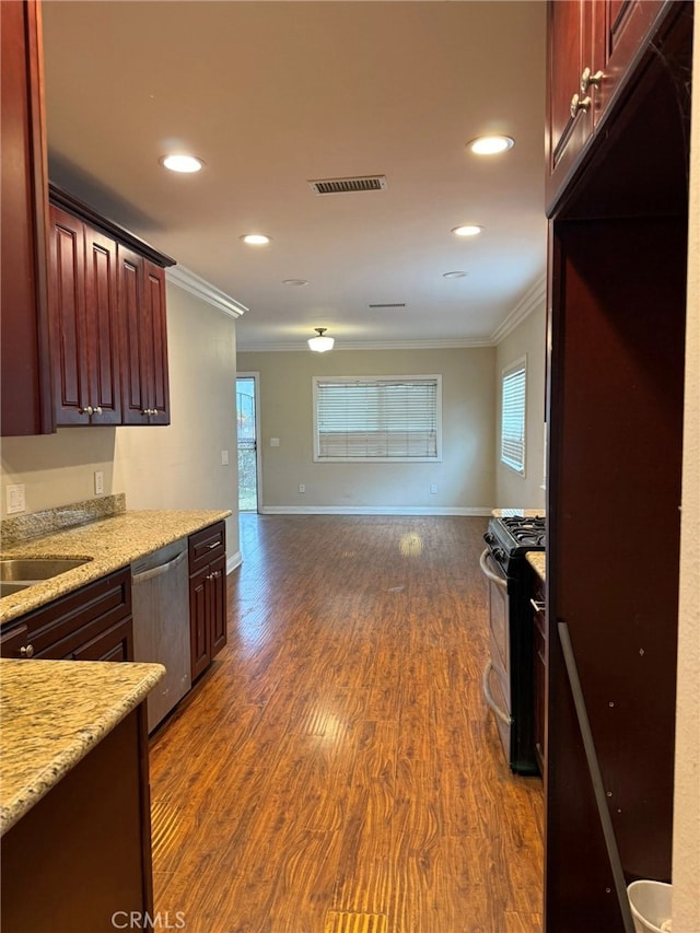 1030 E M St, Wilmington, CA 90744 - kitchen with appliances with stainless steel finishes, ornamental molding, open floor plan, dark wood-type flooring, and recessed lighting