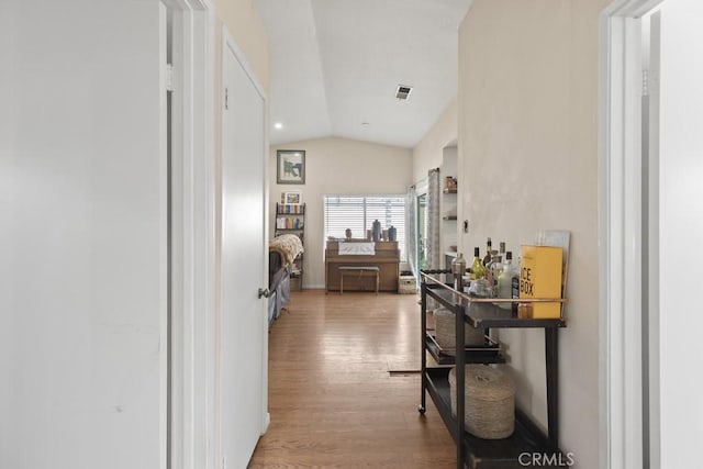 16251 Malaga St, Fontana, CA 92336 - hallway with vaulted ceiling and light wood-style floors