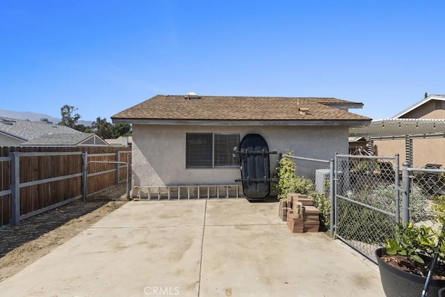 16251 Malaga St, Fontana, CA 92336 - rear view of house featuring a gate, a patio, a fenced backyard, and stucco siding