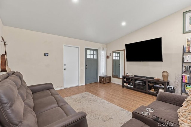 16251 Malaga St, Fontana, CA 92336 - living area with wood finished floors, vaulted ceiling, baseboards, and recessed lighting