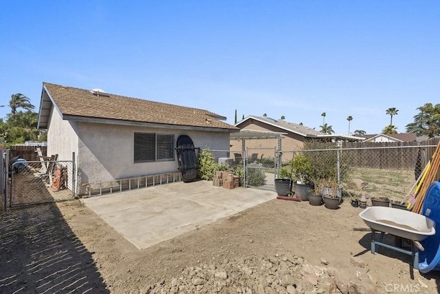 16251 Malaga St, Fontana, CA 92336 - back of property with a gate, a patio, and stucco siding
