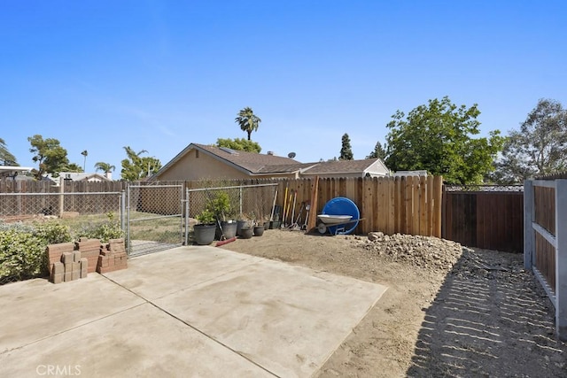16251 Malaga St, Fontana, CA 92336 - fenced backyard featuring a gate and a patio area