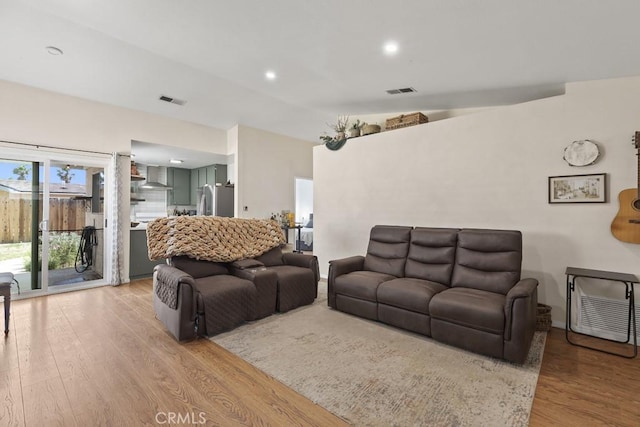 16251 Malaga St, Fontana, CA 92336 - living room featuring light wood-style flooring and recessed lighting