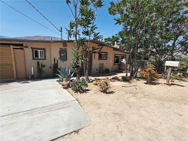 49438 Conejo Rd, Morongo Valley, CA 92256 - view of front of home featuring stucco siding and a patio