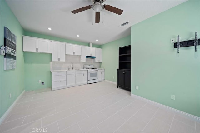 18189 Kalin Ranch Dr, Victorville, CA 92395 - kitchen featuring gas range gas stove, under cabinet range hood, white cabinetry, a ceiling fan, and recessed lighting