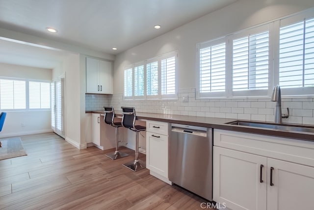 7411 Brava St, Carlsbad, CA 92009 - kitchen with dishwasher, a sink, decorative backsplash, white cabinetry, and light wood finished floors