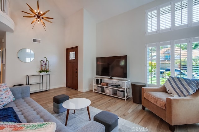 7411 Brava St, Carlsbad, CA 92009 - living area featuring a high ceiling, wood finished floors, and baseboards