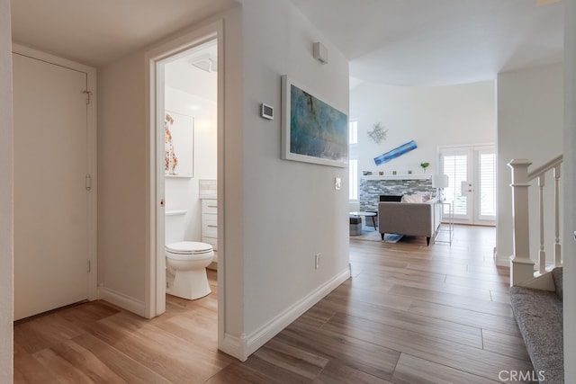 7411 Brava St, Carlsbad, CA 92009 - hallway featuring wood finished floors, stairs, and baseboards