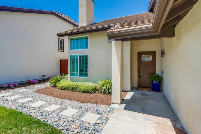 7411 Brava St, Carlsbad, CA 92009 - entrance to property featuring a chimney and stucco siding