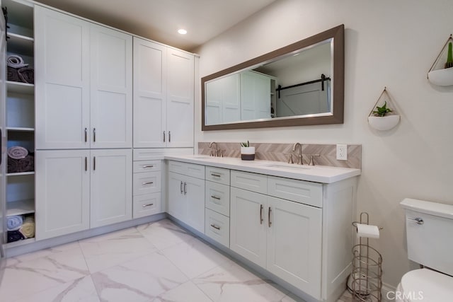 7411 Brava St, Carlsbad, CA 92009 - bathroom with toilet, marble look tile flooring, double vanity, a closet, and recessed lighting