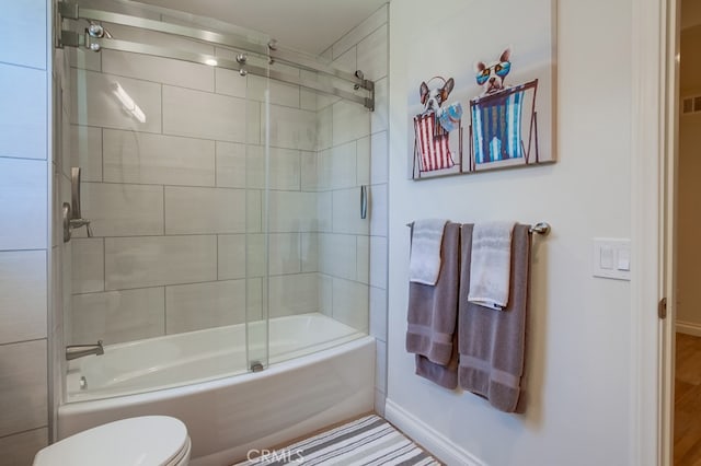 7411 Brava St, Carlsbad, CA 92009 - bathroom featuring baseboards, toilet, and combined bath / shower with glass door