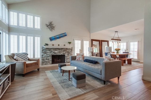 7411 Brava St, Carlsbad, CA 92009 - living area with a high ceiling, light wood-type flooring, and a fireplace