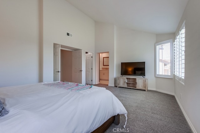 7411 Brava St, Carlsbad, CA 92009 - carpeted bedroom featuring baseboards, ensuite bathroom, and high vaulted ceiling