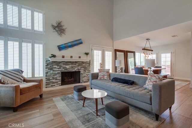 7411 Brava St, Carlsbad, CA 92009 - living room with a high ceiling, light wood finished floors, and a fireplace