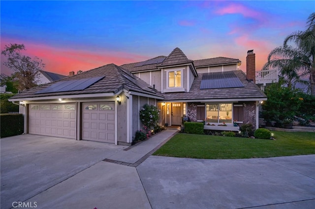 20640 Smoketree Ave, Yorba Linda, CA 92886 - view of front of property with driveway, roof mounted solar panels, a chimney, a yard, and a garage
