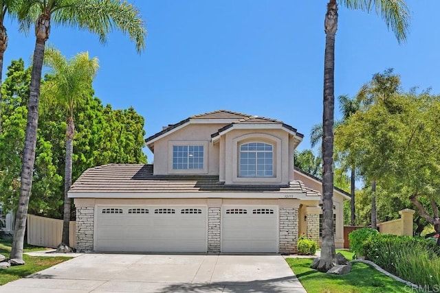 32175 Via Flore, Temecula, CA 92592 - traditional home featuring driveway, stone siding, a garage, stucco siding, and a tile roof