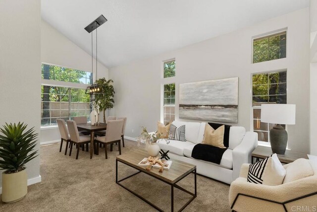 32175 Via Flore, Temecula, CA 92592 - carpeted living area featuring high vaulted ceiling, plenty of natural light, and a chandelier