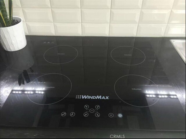 3119 Larga Ave, Los Angeles, CA 90039 - kitchen view of black electric stovetop and white cabinetry