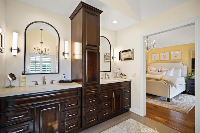 6617 Oak Forest Dr, Oak Park, CA 91377 - full bath with a chandelier, ensuite bath, double vanity, wood finished floors, and recessed lighting