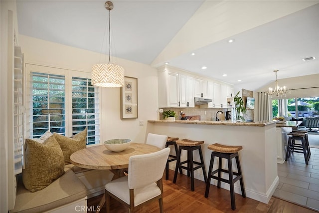 6617 Oak Forest Dr, Oak Park, CA 91377 - dining area featuring lofted ceiling, a chandelier, dark wood-style floors, and recessed lighting