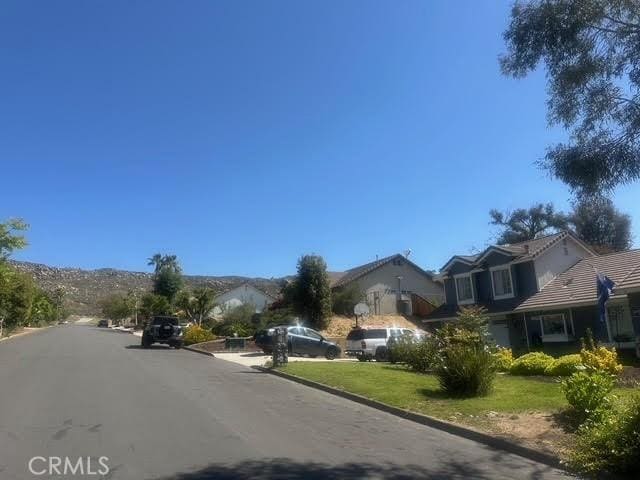 11420 Lasselle St, Moreno Valley, CA 92557 - view of asphalt street featuring curbs and a residential view
