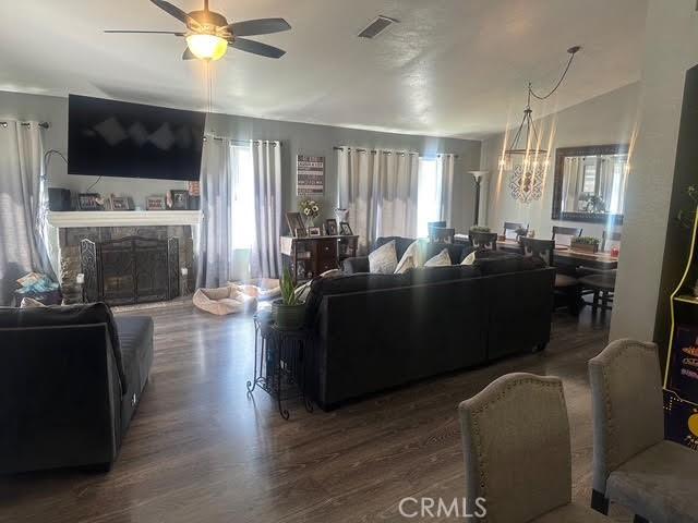 11420 Lasselle St, Moreno Valley, CA 92557 - living area featuring a ceiling fan, wood finished floors, and plenty of natural light