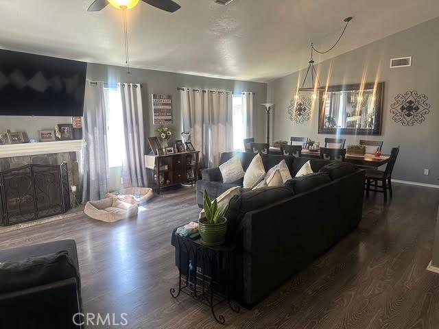 11420 Lasselle St, Moreno Valley, CA 92557 - living room with plenty of natural light, a ceiling fan, and wood finished floors