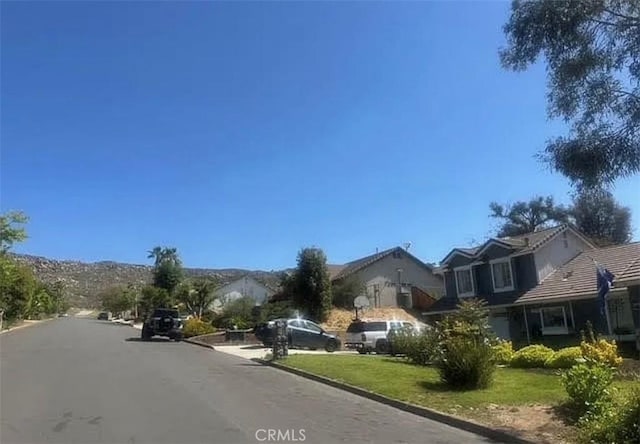 11420 Lasselle St, Moreno Valley, CA 92557 - view of asphalt road featuring curbs and a residential view