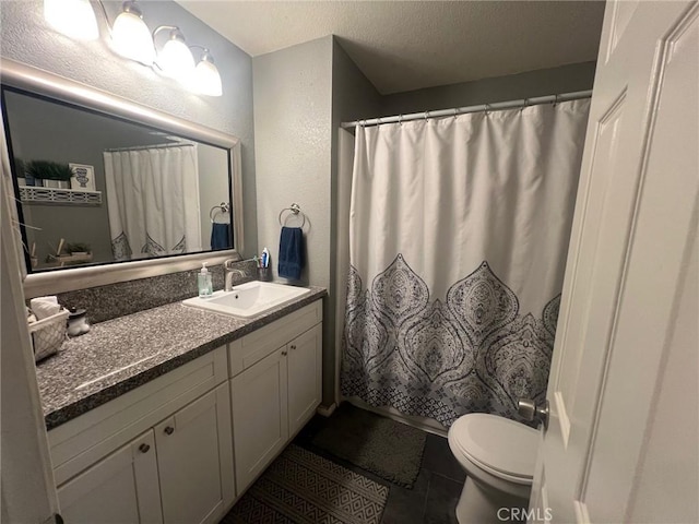 11420 Lasselle St, Moreno Valley, CA 92557 - full bathroom featuring vanity, toilet, a textured wall, tile patterned floors, and a shower with shower curtain