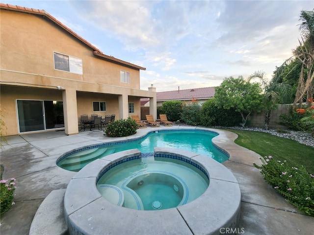 43620 Brahea Ct, Indio, CA 92201 - view of pool with a pool with connected hot tub, a patio, a fenced backyard, and outdoor dining space